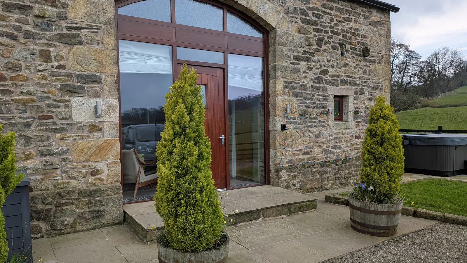 Hill Brook Barn exterior entrance — stone walls and open countryside beyond