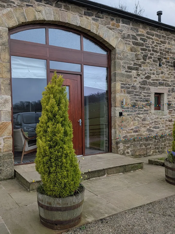 Hill Brook Barn exterior — stone walls set in the open Lancashire countryside