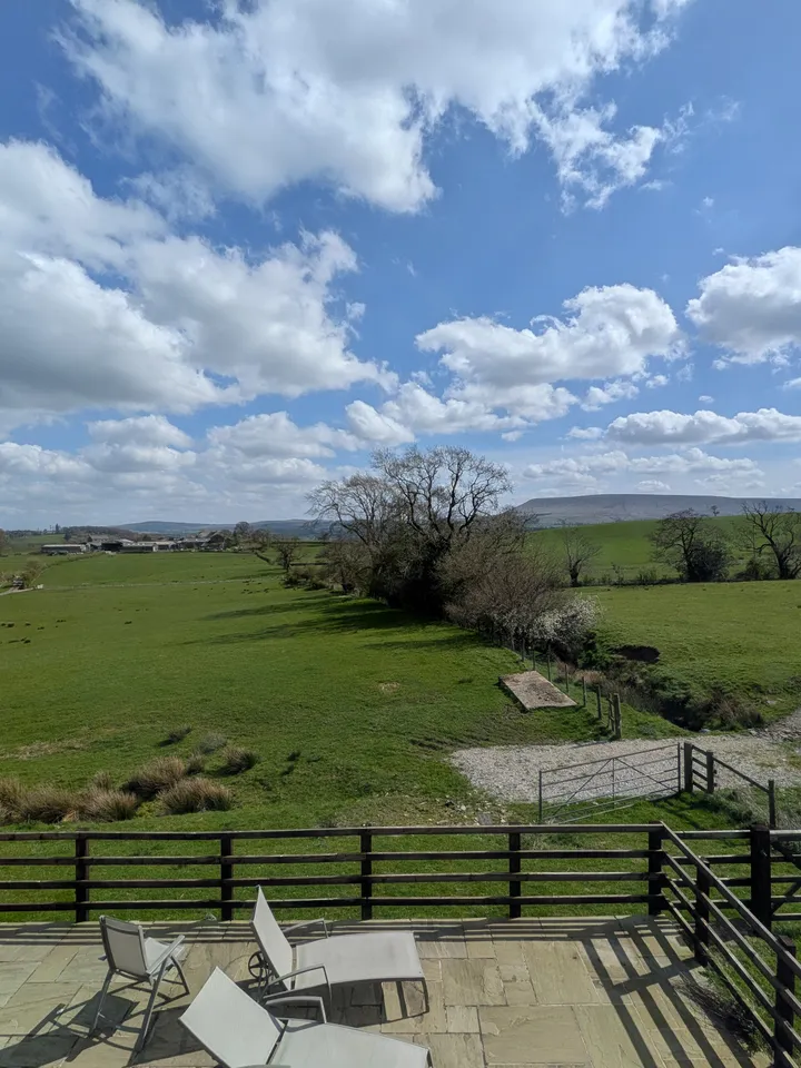 Pendle Hill seen across open fields from the terrace at Hill Brook Barn