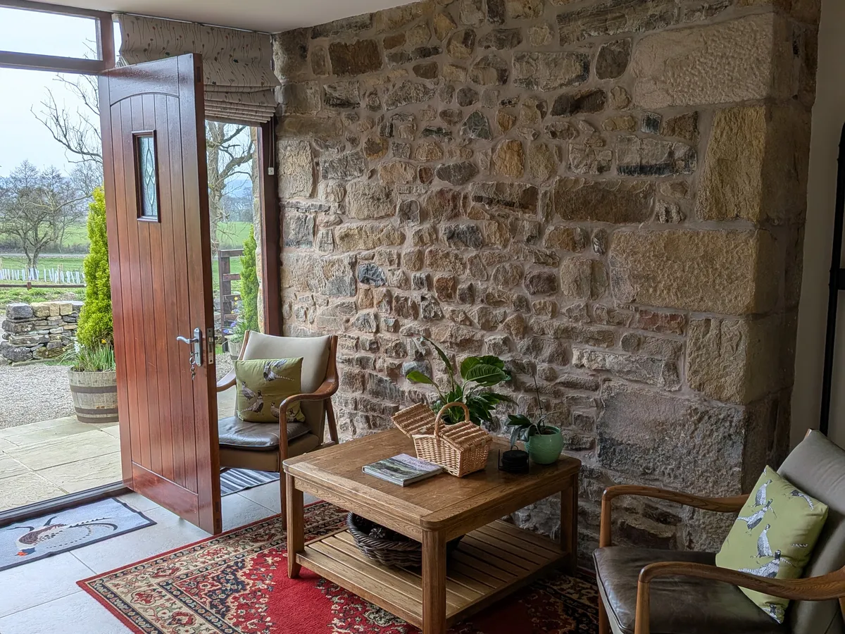 Entrance hall with exposed original stone wall