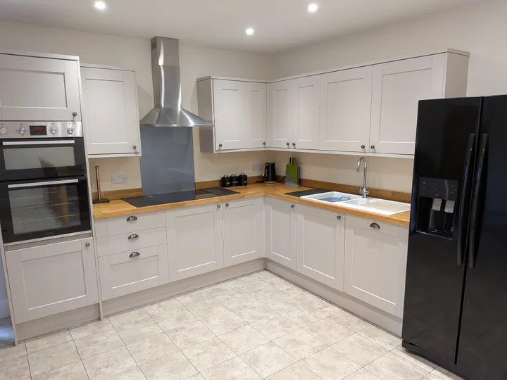 Kitchen with shaker cabinets and oak worktops at Hill Brook Barn